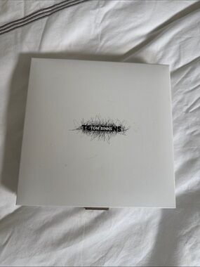 Tom Binns white jewelry presentation box with black logo